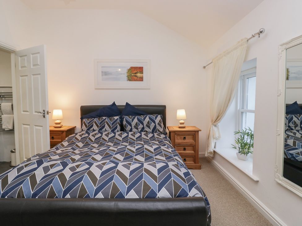 A bedroom with a bed and bedside table at Newlands Fell House near Keswick