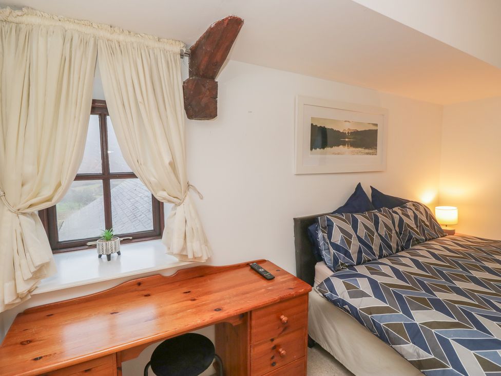 A bedroom with a bed and desk at Newlands Fell House near Keswick
