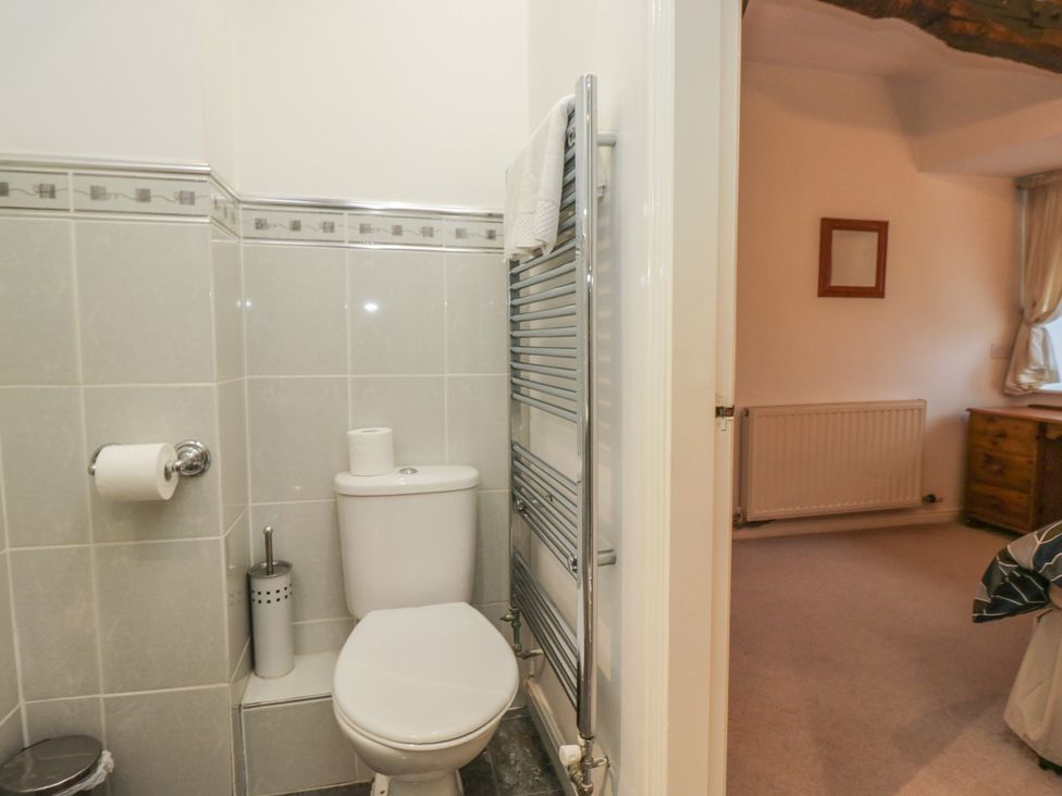 A bathroom with a toilet and towel rail at Newlands Fell House in Newlands near Keswick