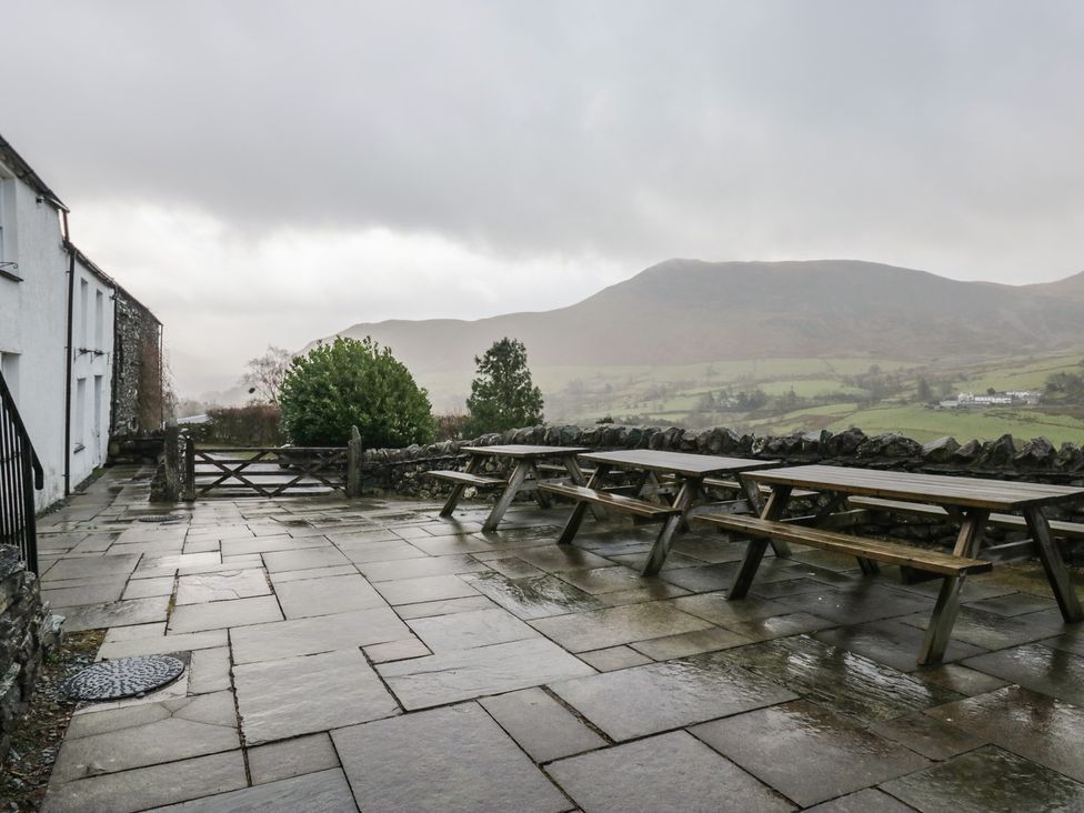 An outdoor area with benches and tables at Newlands Fell House in Newlands near Keswick
