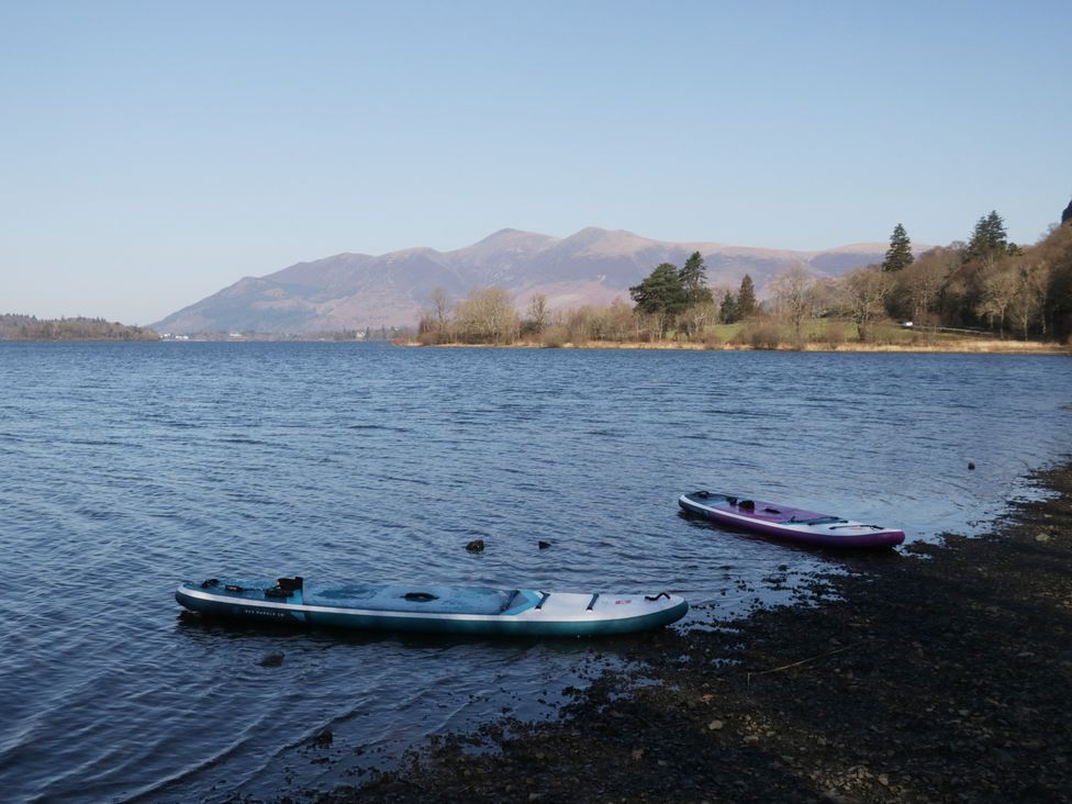 Two kayaks on a calm lake with mountains in the background at Newlands Fell House in Newlands near Keswick