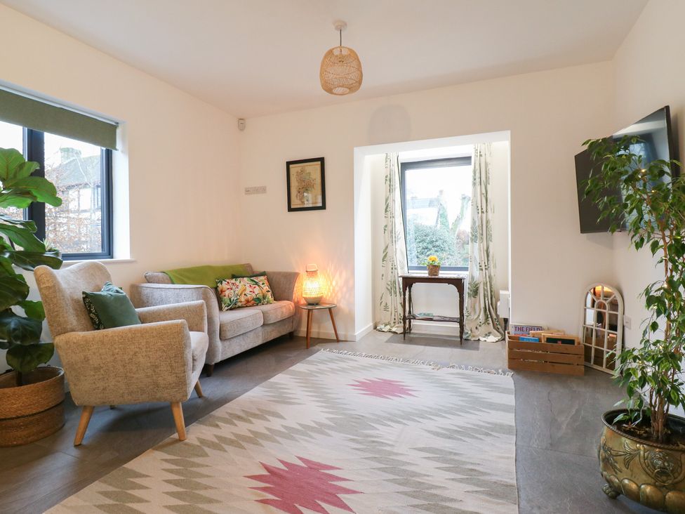 A living room with a sofa and armchair at The Kiln in Colmworth