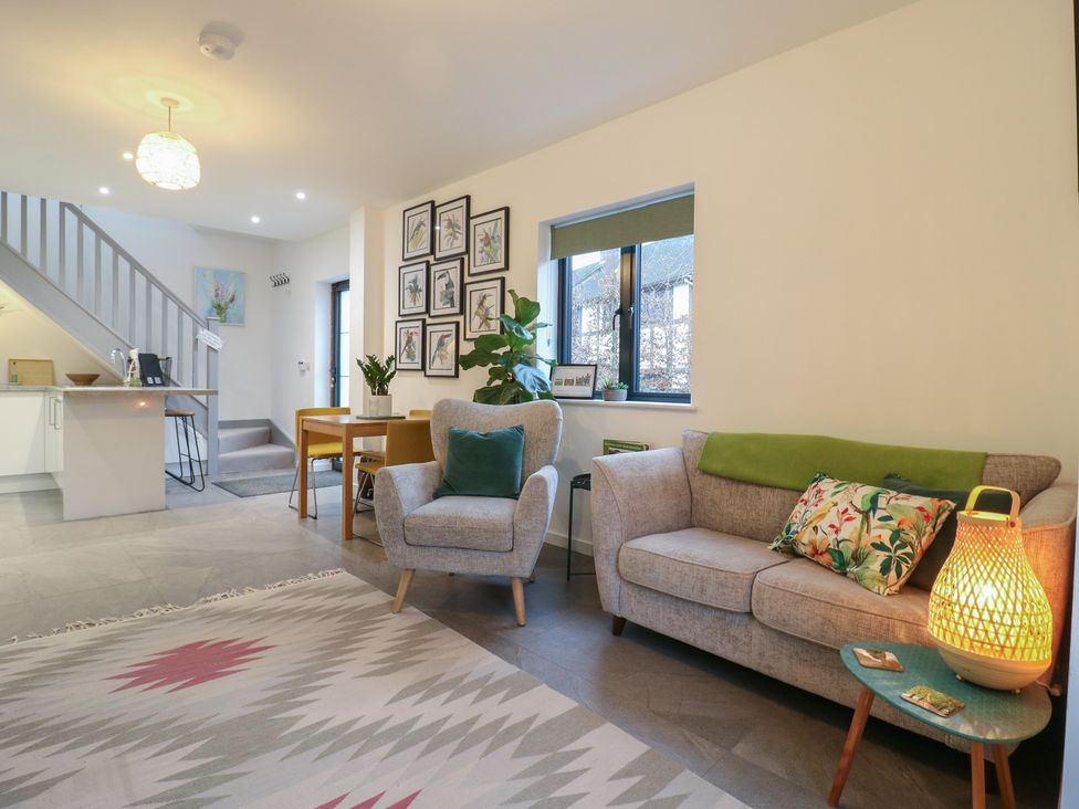 A living room with a sofa and dining table at The Kiln in Colmworth