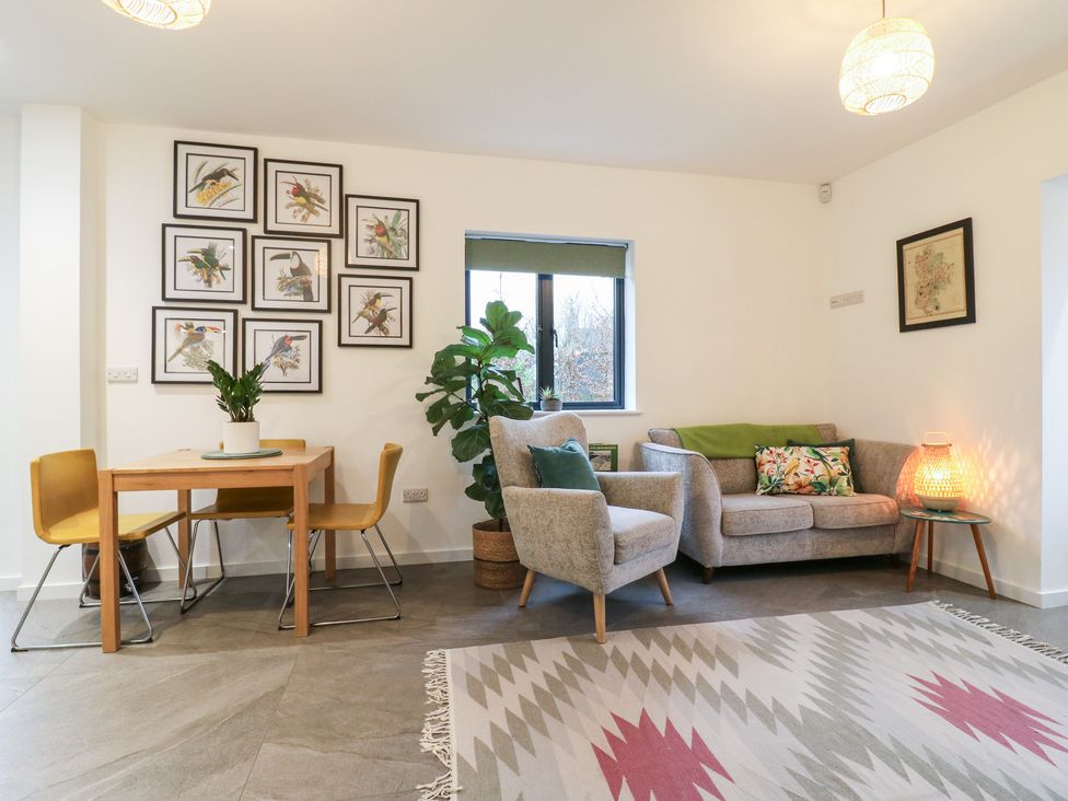 A living room with a sofa and dining table at The Kiln in Colmworth