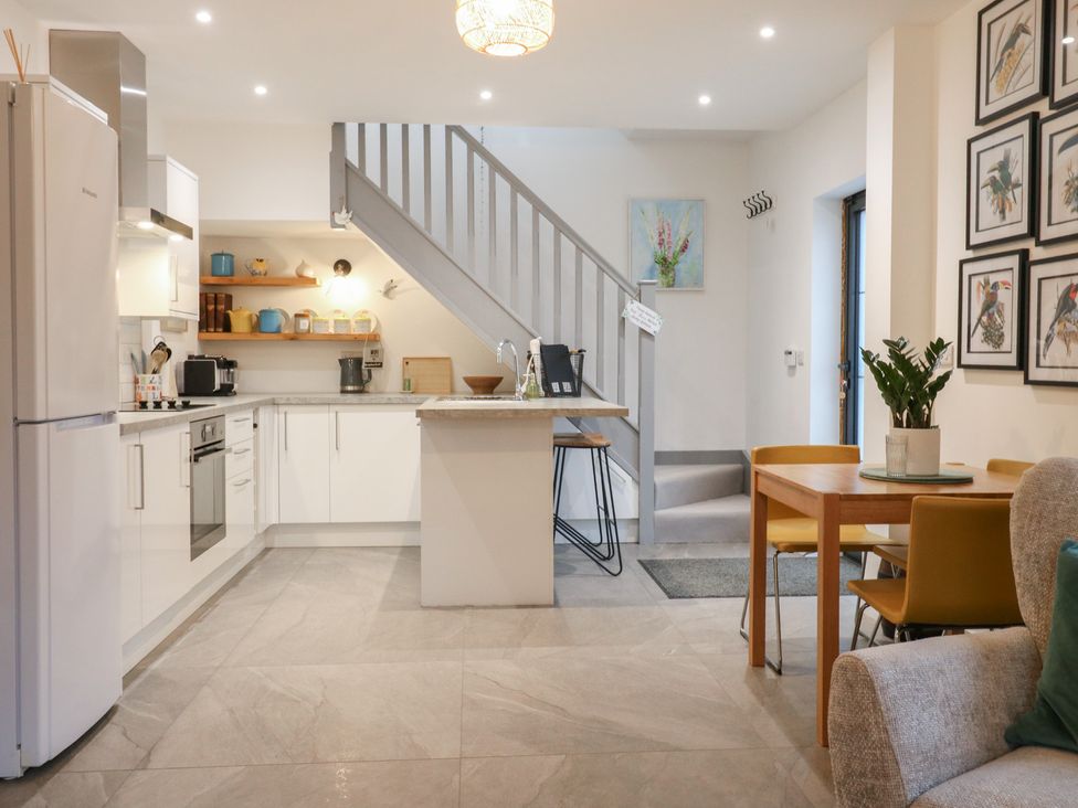 A kitchen with appliances and seating at The Kiln in Colmworth