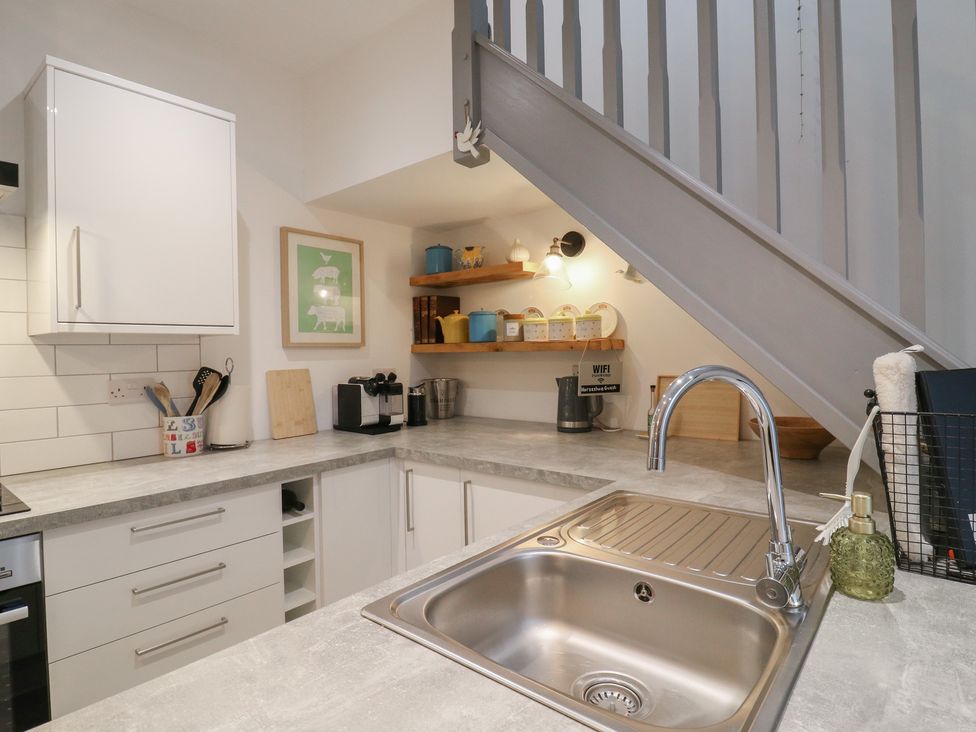 A kitchen with a sink and countertop at The Kiln in Colmworth