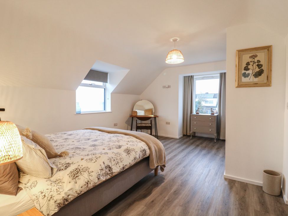 A bedroom with a bed and mirror at The Kiln in Colmworth