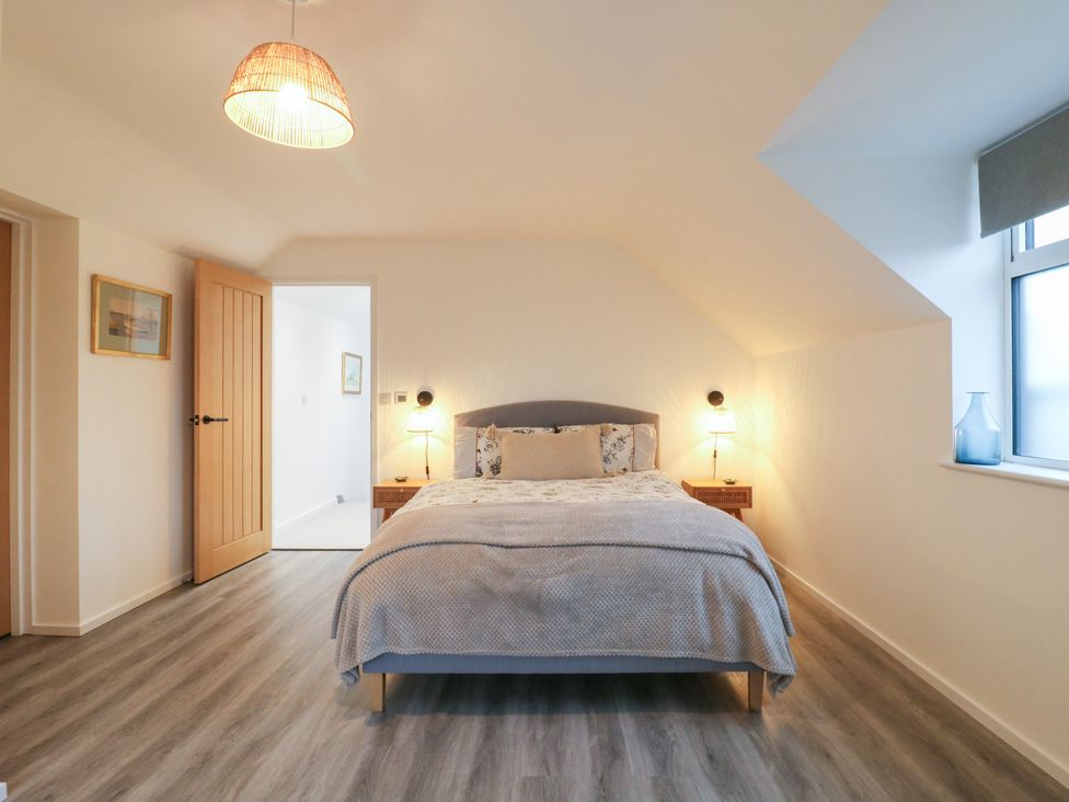 A bedroom with a bed and nightstands at The Kiln in Colmworth