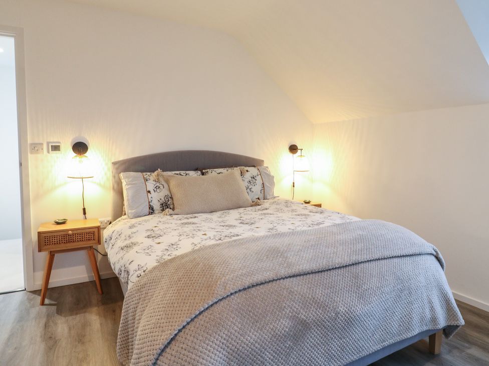 A bedroom with a bed and bedside table at The Kiln in Colmworth