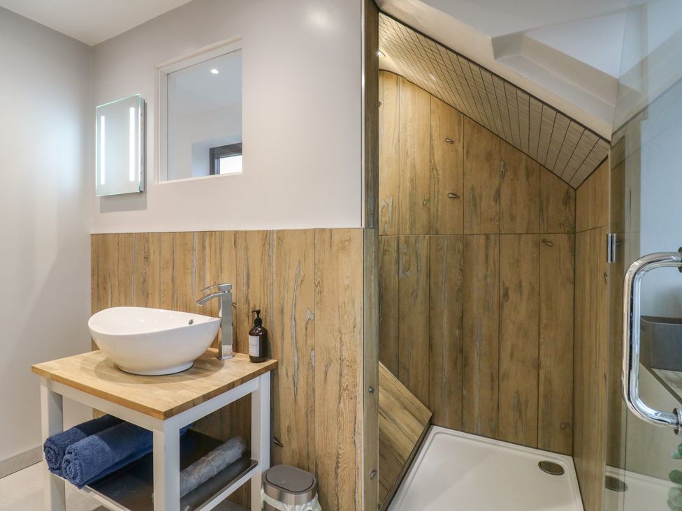 A bathroom with a sink and shower at The Kiln in Colmworth