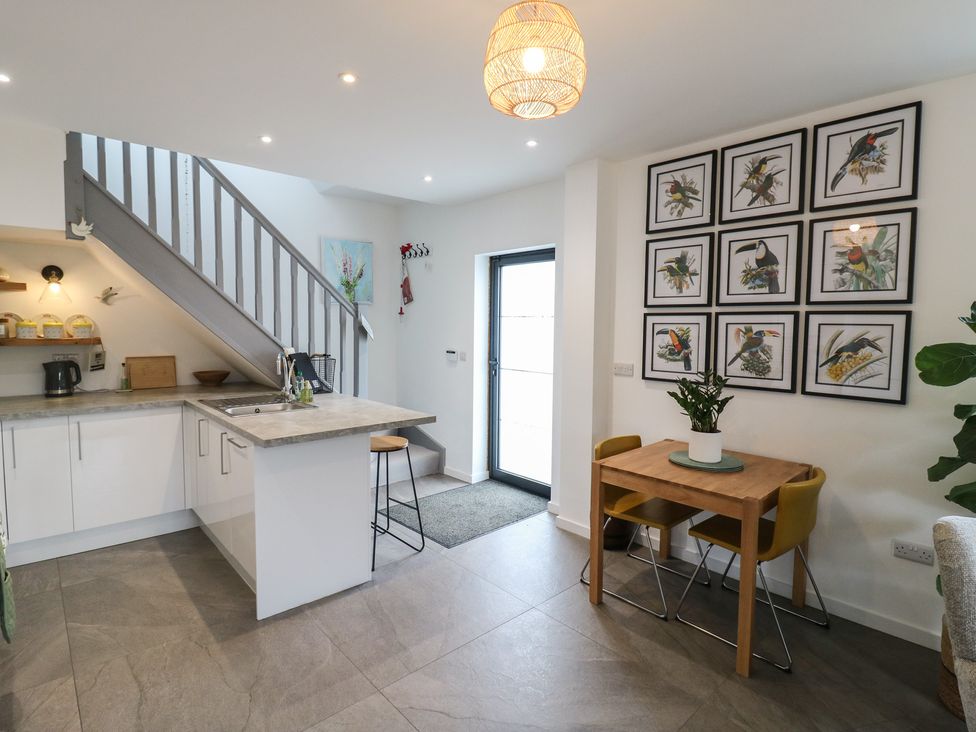 A kitchen with a staircase and dining area at The Kiln in Colmworth