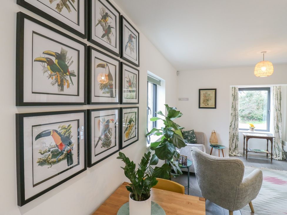 A living room with framed pictures on a wall at The Kiln in Colmworth