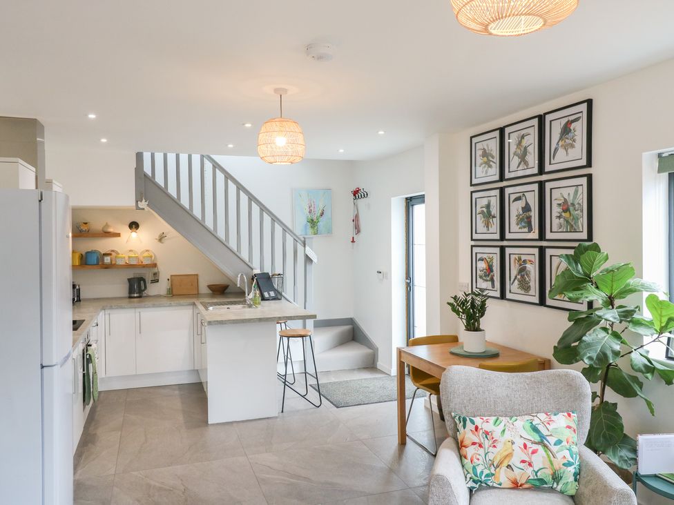 A kitchen with appliances and dining furniture at The Kiln in Colmworth