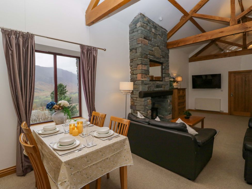 A living room with a table and chairs at Newlands Fell Cottage in Newlands near Keswick