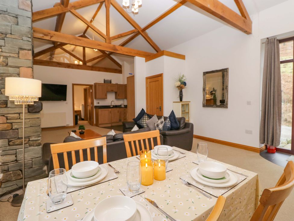 A dining room with a table set for dinner at Newlands Fell Cottage in Newlands near Keswick