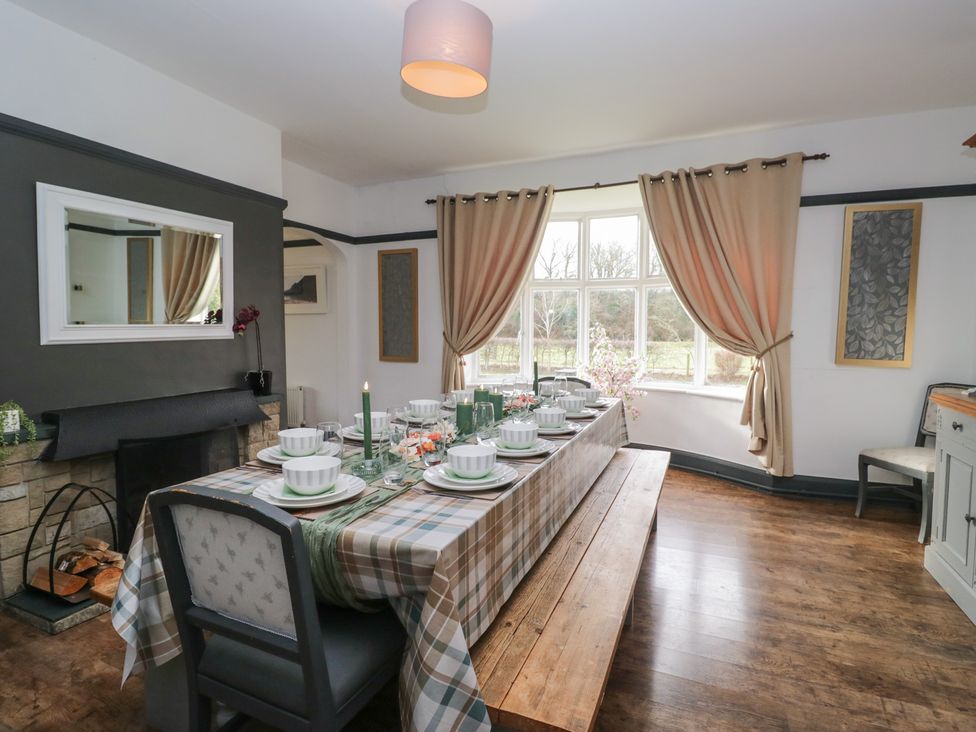 A dining room with a table set for dinner at Herdwick Croft in Bassenthwaite