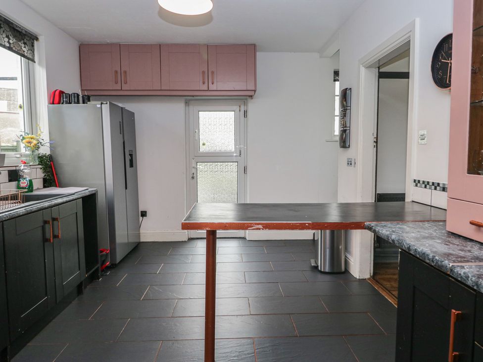 A kitchen with appliances and countertop at Herdwick Croft in Bassenthwaite