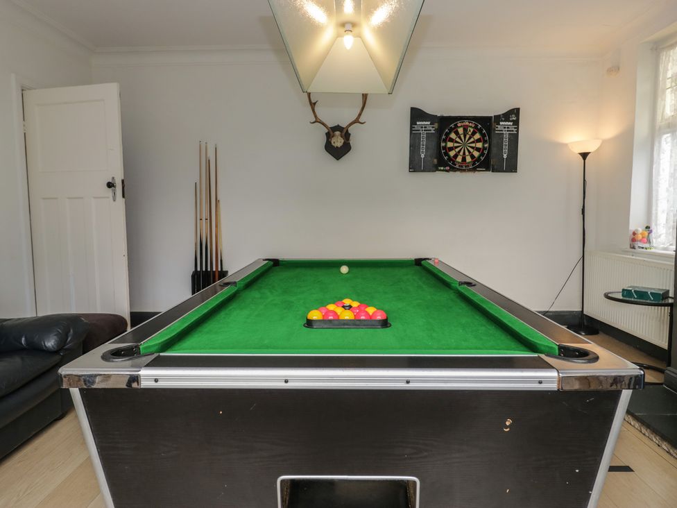 A pool table and dartboard in a snug at Herdwick Croft in Bassenthwaite