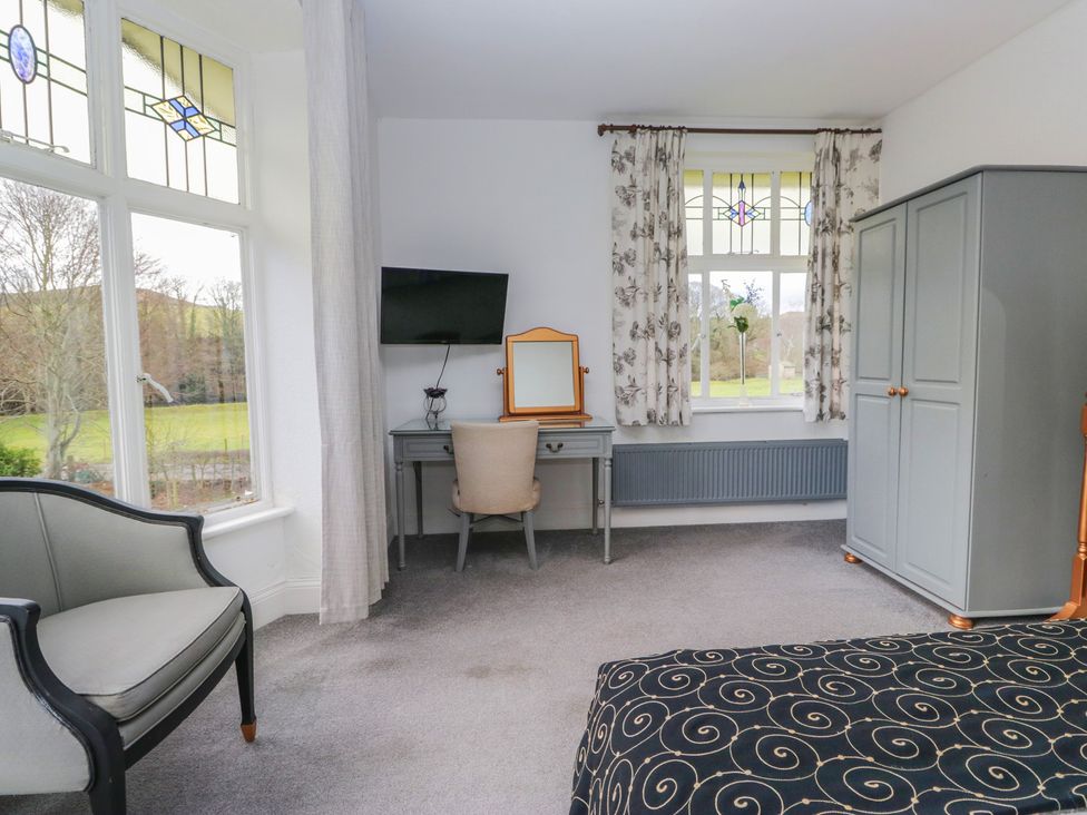 A bedroom with a desk and chair at Herdwick Croft in Bassenthwaite