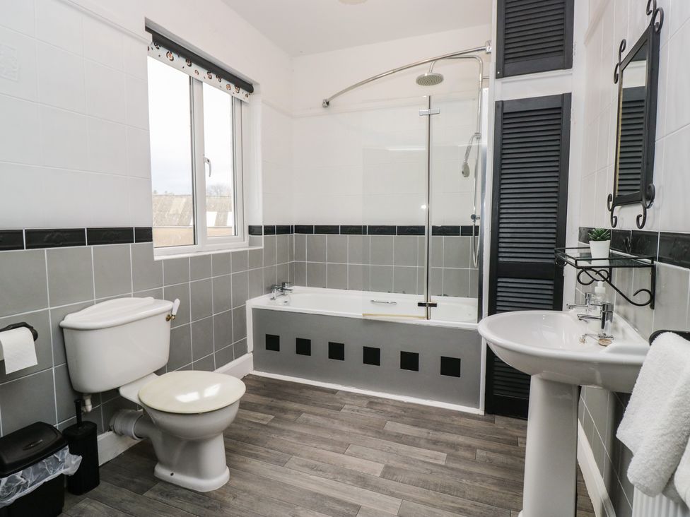A bathroom with a bathtub, toilet, and sink at Herdwick Croft, Bassenthwaite
