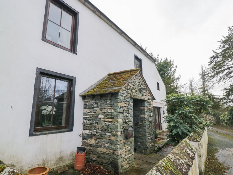 An outdoor stone entrance with plants at Birkbank Farm in Cockermouth
