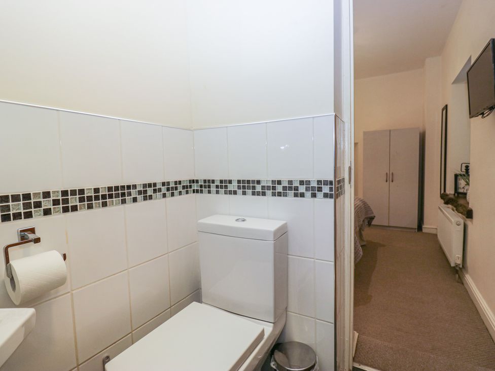 A bathroom with a toilet and sink at Birkbank Farm Cockermouth