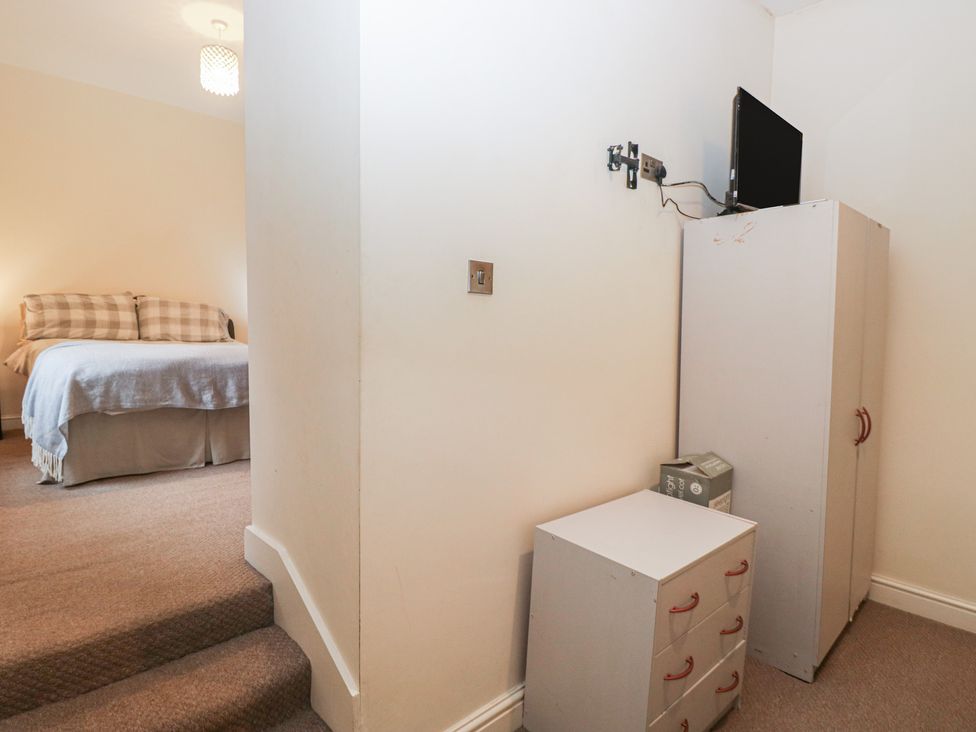 A bedroom with a bed and TV at Birkbank Farm in Cockermouth