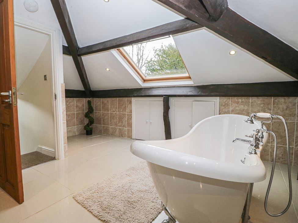 A bathroom with a bathtub and skylight at Birkbank Farm Cockermouth