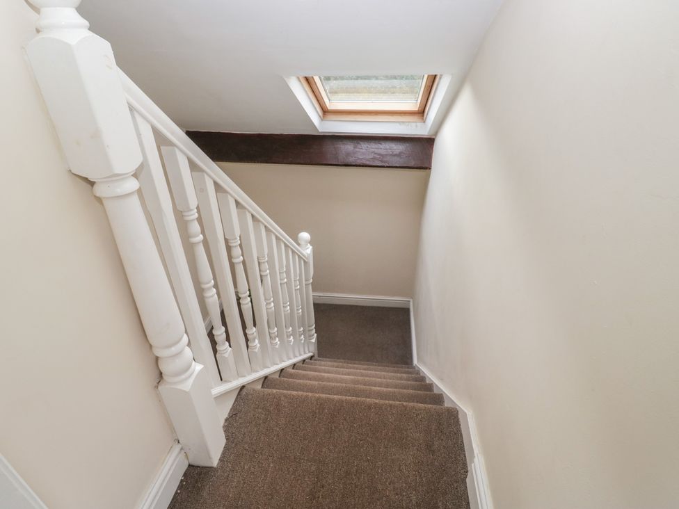 A stairway with a railing and a skylight at Birkbank Farm in Cockermouth