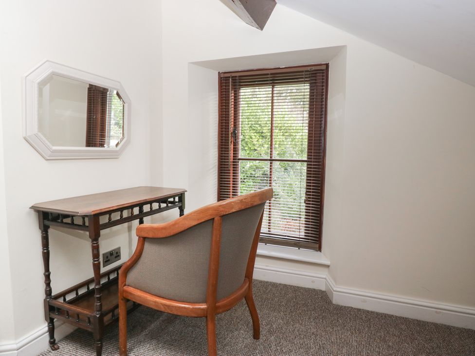 A study area with a chair and table at Birkbank Farm in Cockermouth