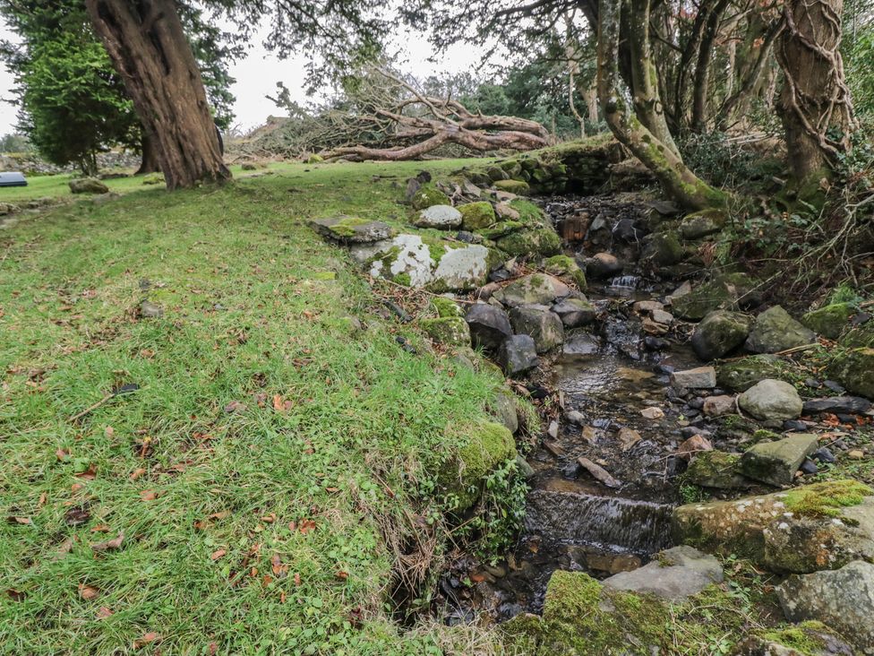 A stream with rocks and grass area at Birkbank Farm Cockermouth