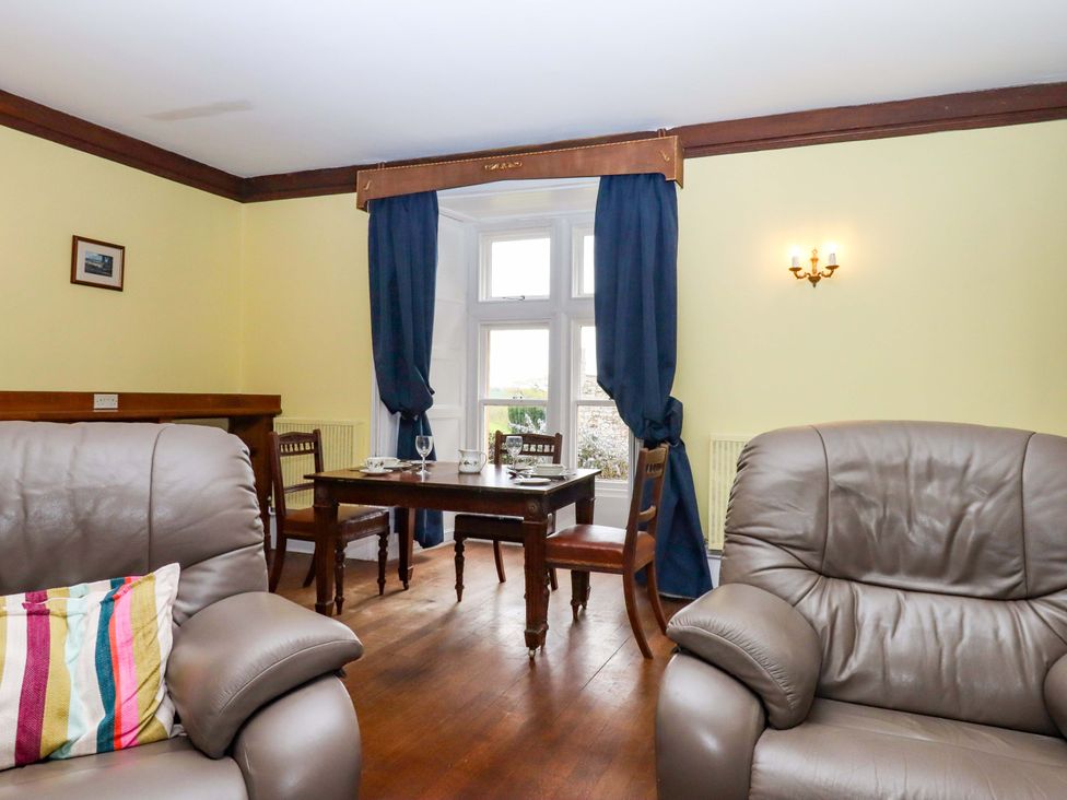 A dining room with chairs and a table at Dowrich West Wing Apartment in Crediton