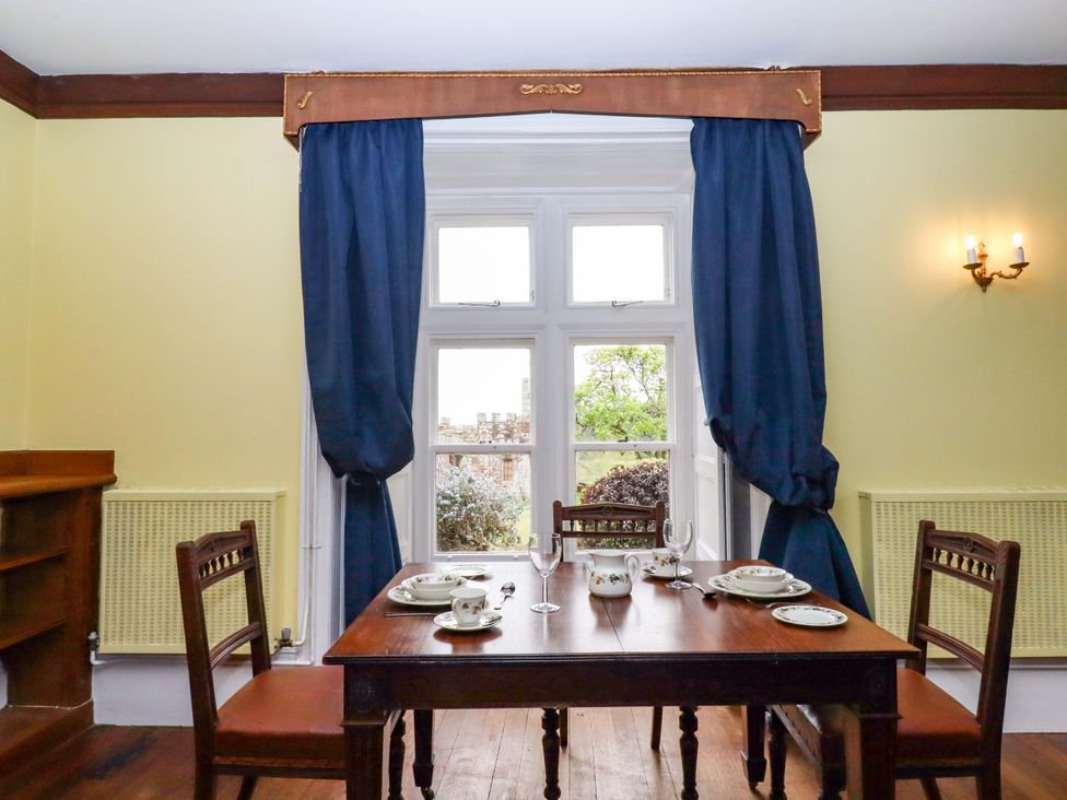 A dining room with a table set for meals at Dowrich West Wing Apartment in Crediton