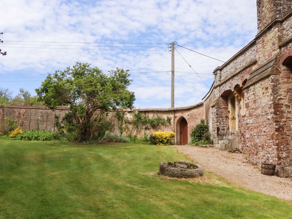 A garden with a tree and pathway at Dowrich West Wing Apartment in Crediton