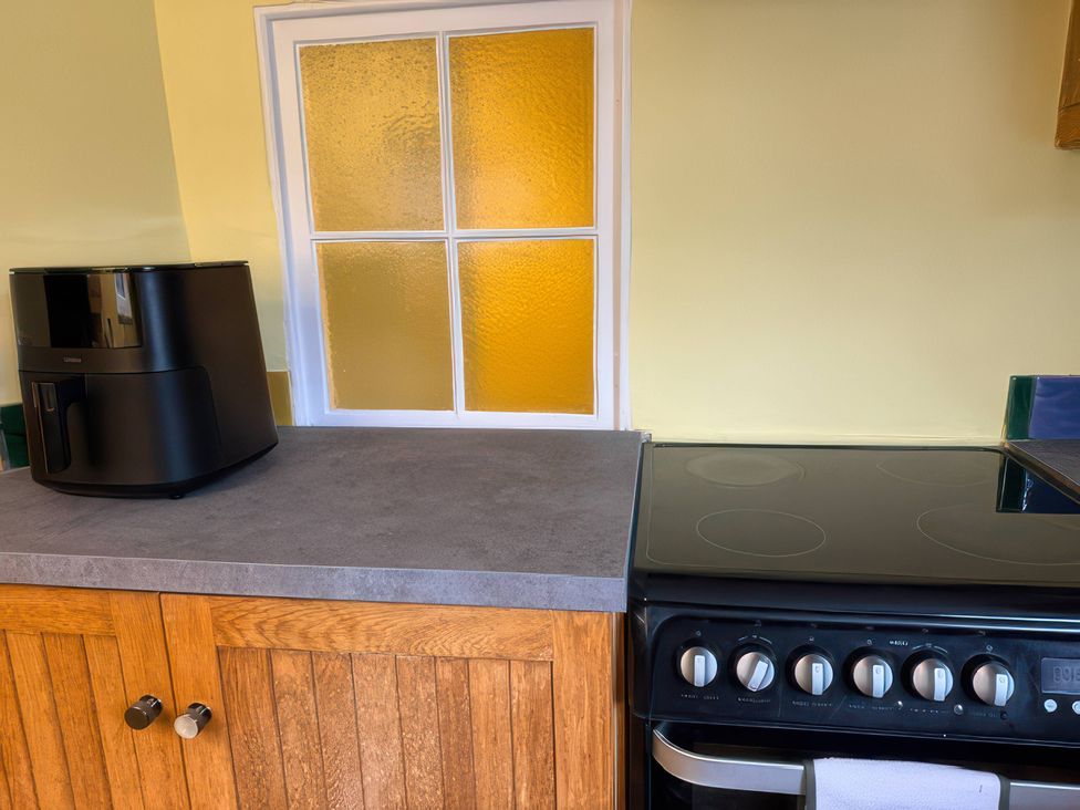 A kitchen with an air fryer and an oven at Dowrich West Wing Apartment near Sandford, Devon