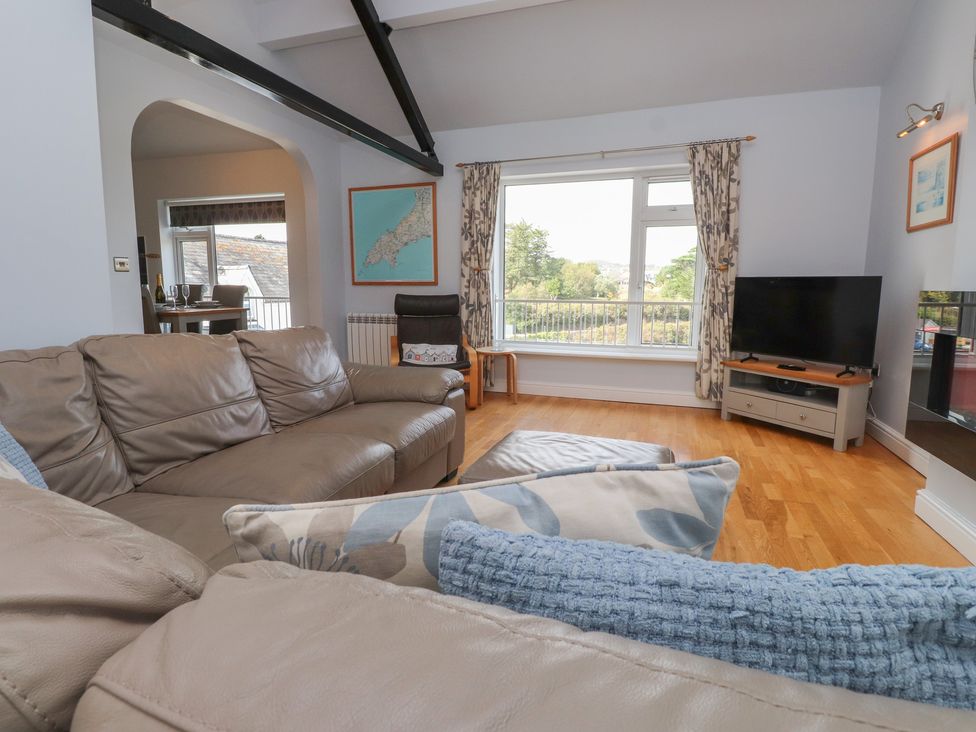 A living room with a sofa and television at Flat 1 in 