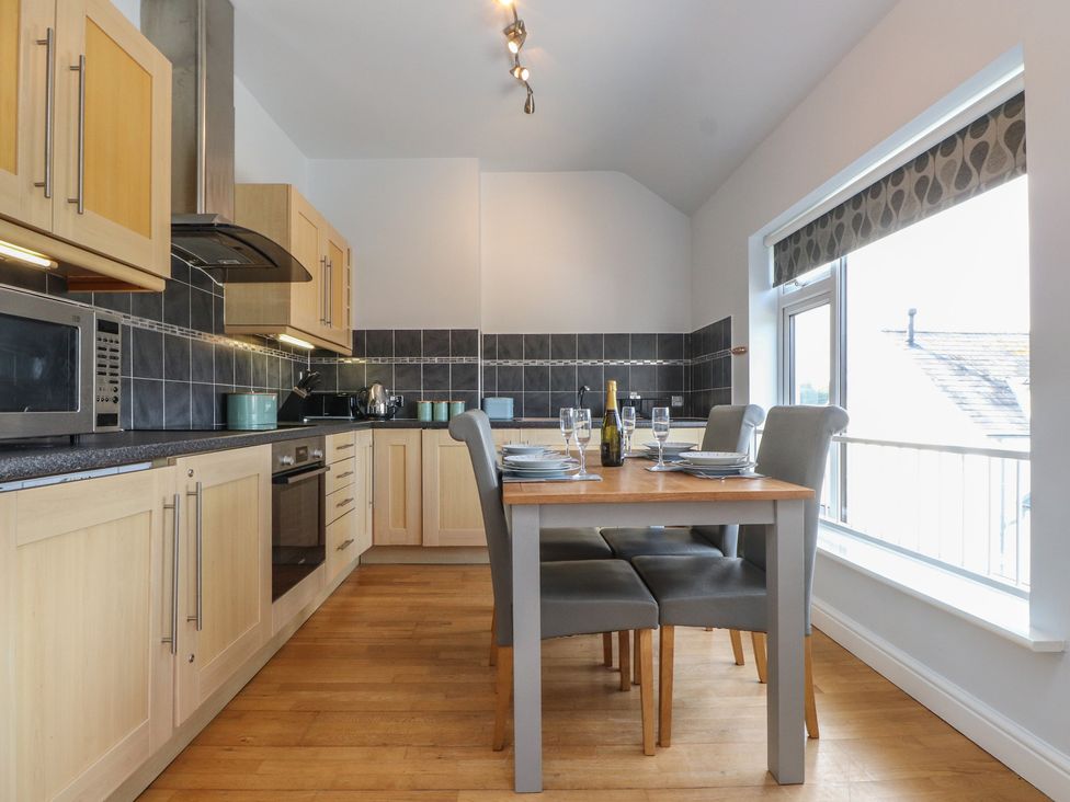 A kitchen with dining table and chairs at Flat 1