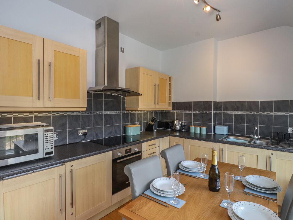 A kitchen with cabinets and appliances at Flat 1