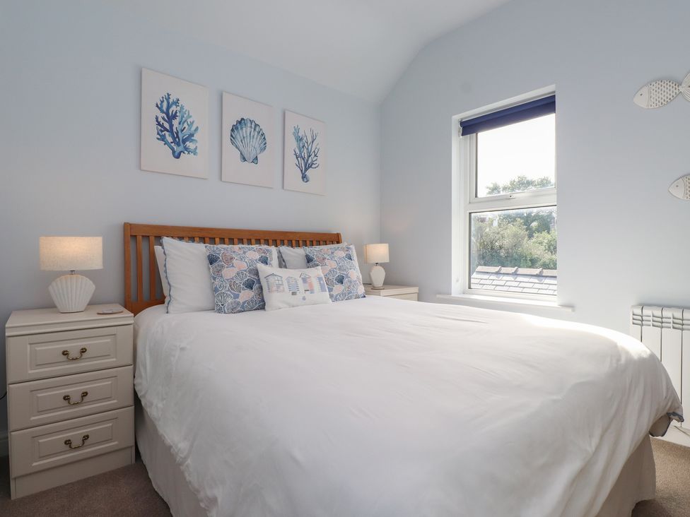 A bedroom with a bed and art on the wall at Flat 1