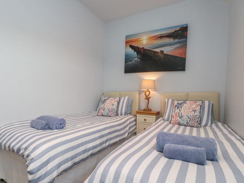 A bedroom with two beds and a lamp at Flat 1 in 
