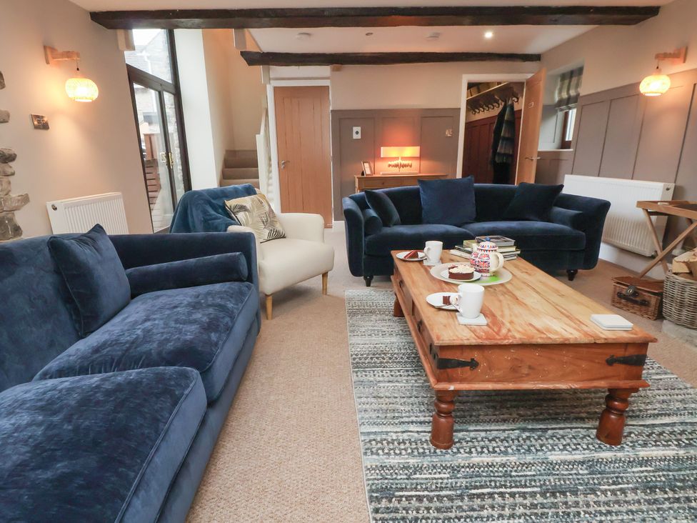 A living room with sofas and a coffee table at The Forge in Castleton, Peak District