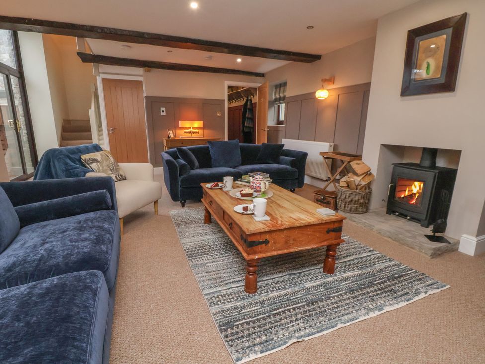 A living room with a fireplace and coffee table at The Forge in Castleton, Peak District