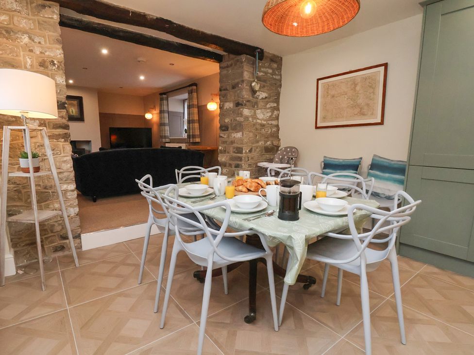 A dining room with a table set for breakfast at The Forge in Castleton, Peak District