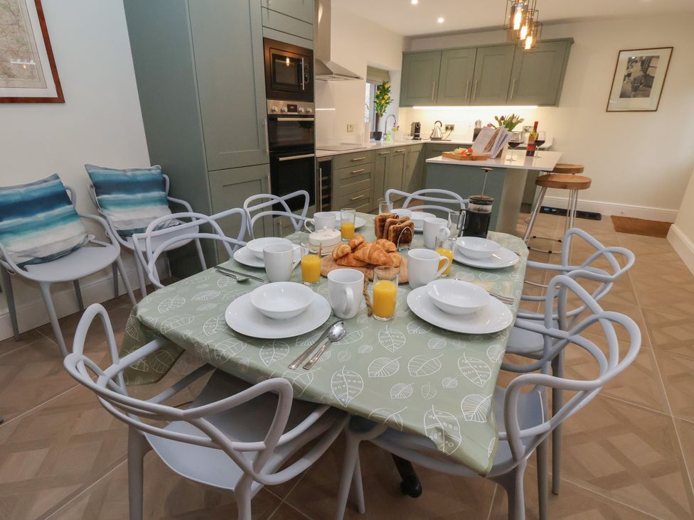A kitchen with a dining table set for breakfast at The Forge in Castleton, Peak District