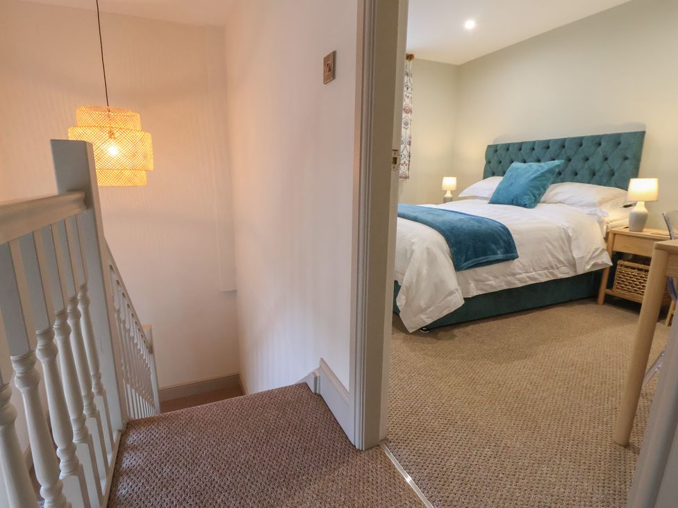 A bedroom with a bed and bedside table at The Forge in Castleton, Peak District