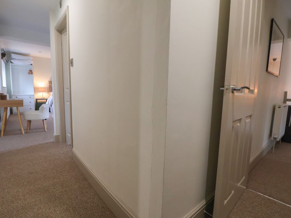 A hallway with a door and furniture visible at The Forge in Castleton, Peak District