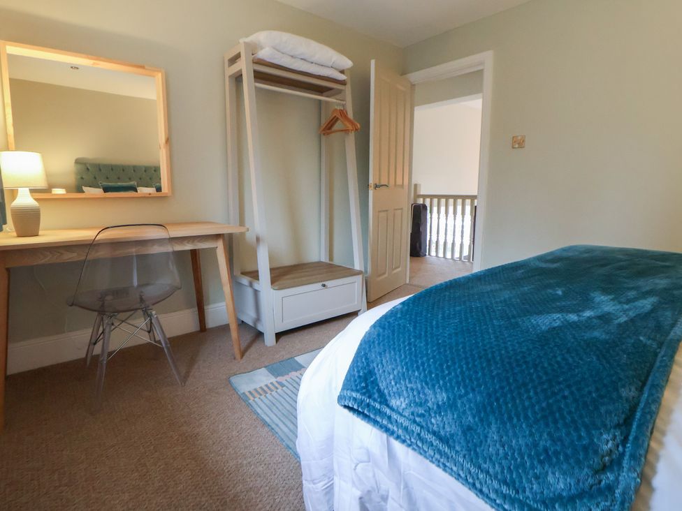 A bedroom with a bed, desk, and wardrobe at The Forge in Castleton, Peak District