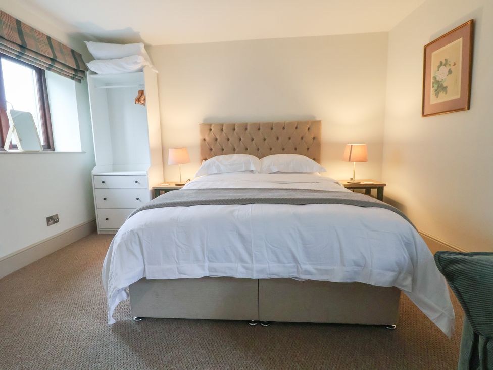 A bedroom with a bed and bedside tables at The Forge in Castleton, Peak District