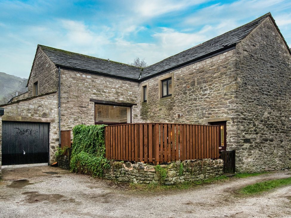 An exterior view of a house with a fence at The Forge in Castleton, Peak District