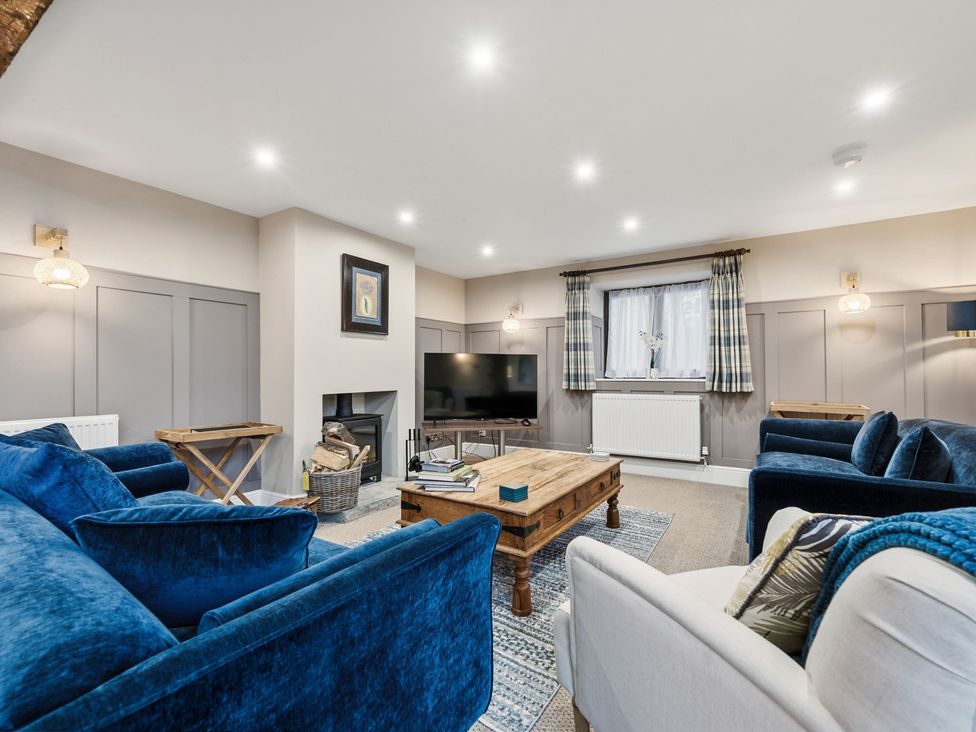 A living room with a tv and coffee table at The Forge in Castleton, Peak District